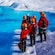 Guests standing near an ice crevasse on a glacier